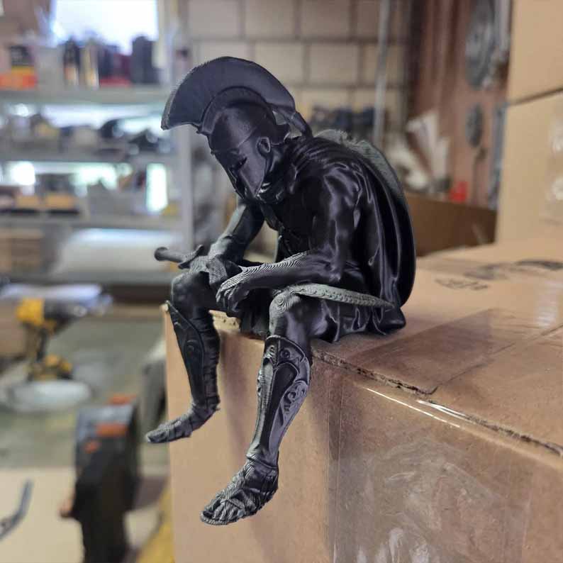 Warrior statue seated on furniture edge with hanging legs